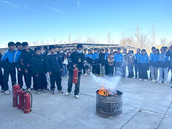 1701414611952479.jpeg 12.1搭建平臺拓視野稿件配圖:學(xué)生們體驗滅火器.jpg