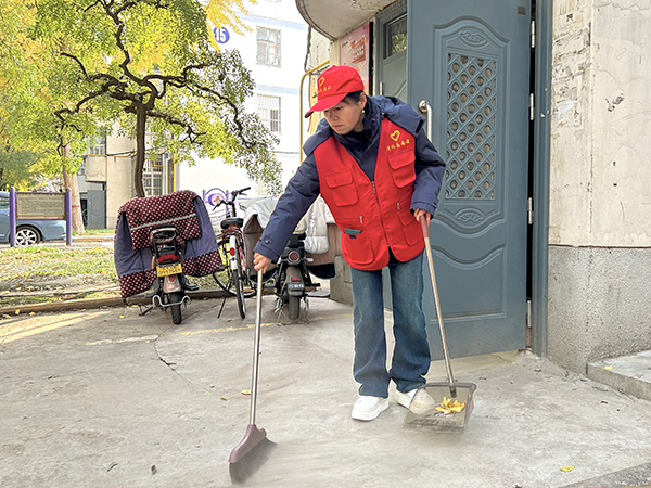 1732265499292066.jpeg 志愿者清掃樓道門口衛生.jpg